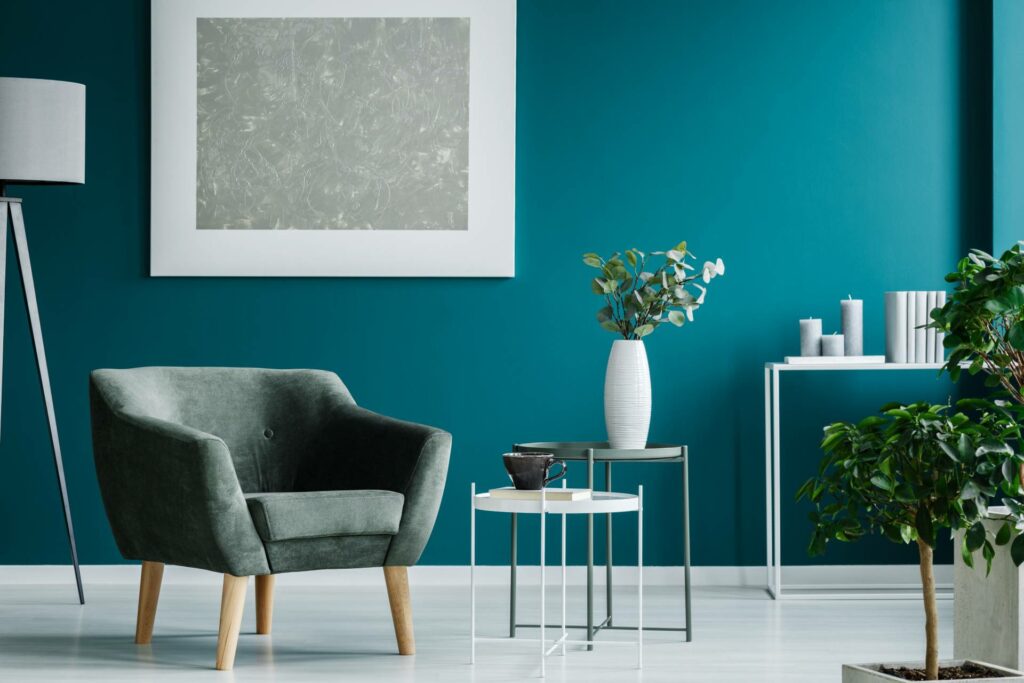 Living room with green armchair, Coffee table, and teal walls.